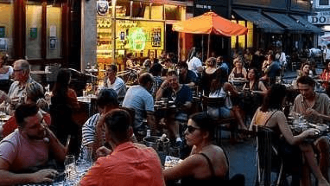 People dining at pavement pizza restaurant