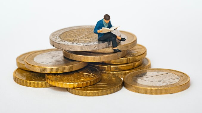Man sitting on pile of coins