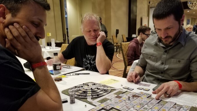 Players engrossed in boardgame