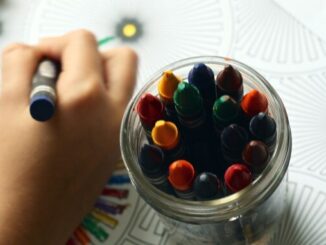 Child's hand drawing with crayons